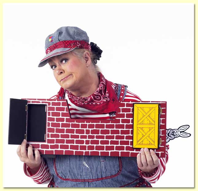 Picture of Margaret Clauder as Engineer Maggie, holding a magic trick where Reader Rabbit shows up in an unexpected location.