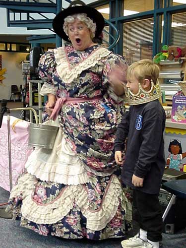 Photograph of Mother Goose with a boy helper.